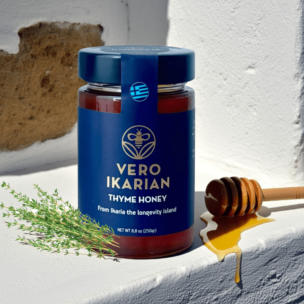 Jar of Ikarian Thyme Honey with a honey dipper on a textured surface