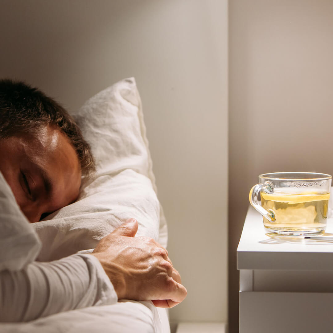A woman relaxing with a cup of chamomile tea