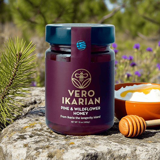 Jar of Ikarian Pine & Wildflower Honey on a stone surface with natural background
