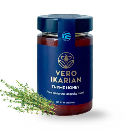 Jar of Ikaria Thyme Honey with a blue label and thyme sprig on a white background