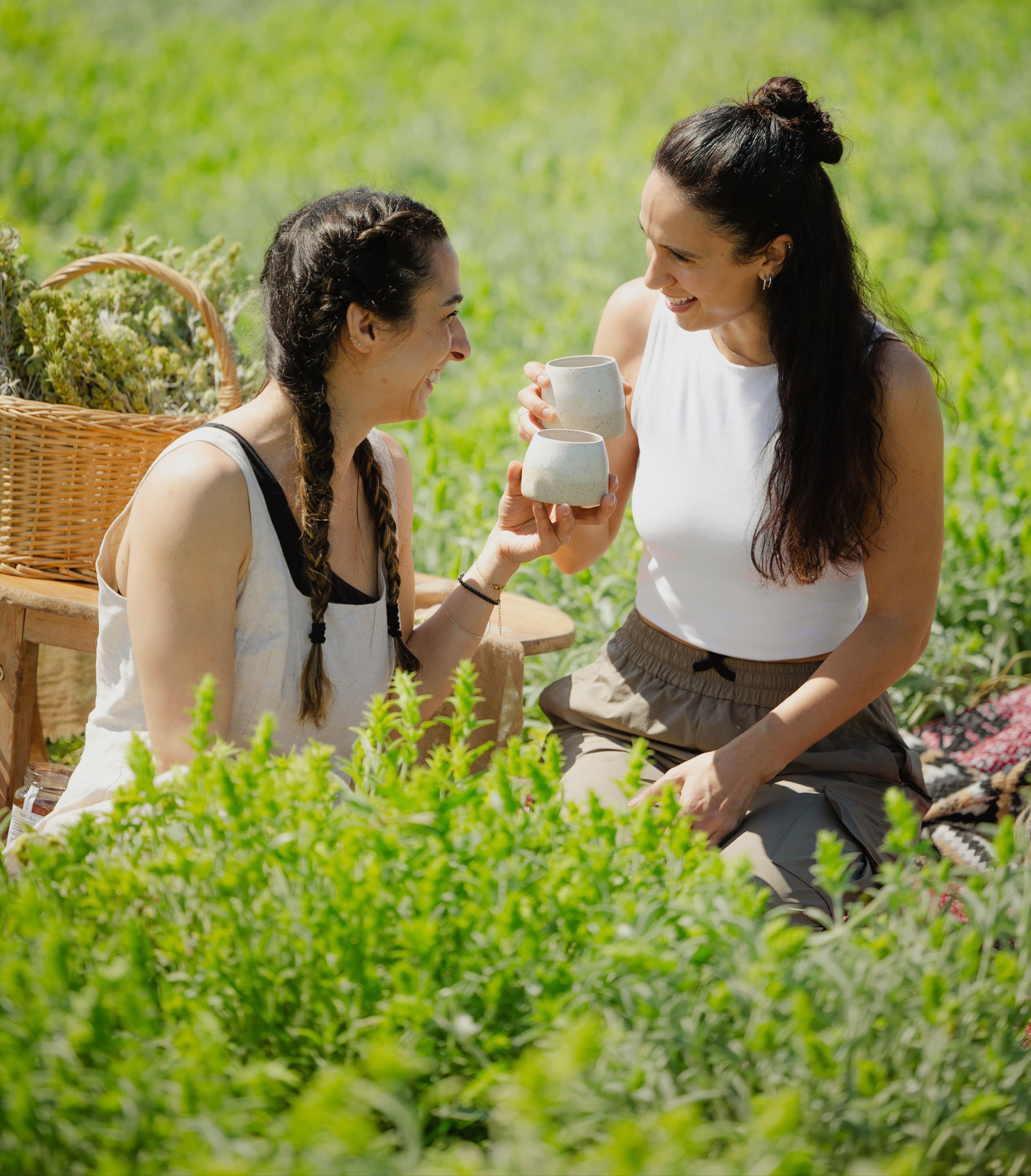 friends enjoying greek mountain tea outside in the sun